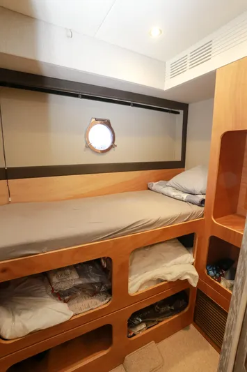  Yacht Photos Pics Cozy cabin interior of 2019 Azimut Magellano 53 yacht with bunk bed and porthole.