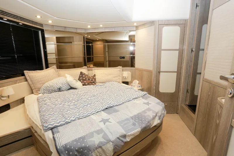  Yacht Photos Pics Luxurious bedroom interior of 2019 Azimut Magellano 53 yacht with cozy bedding and modern design.