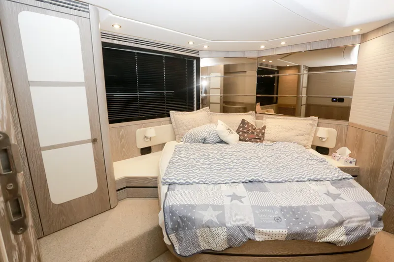  Yacht Photos Pics Luxurious bedroom interior of 2019 Azimut Magellano 53 yacht with cozy bedding and modern design.