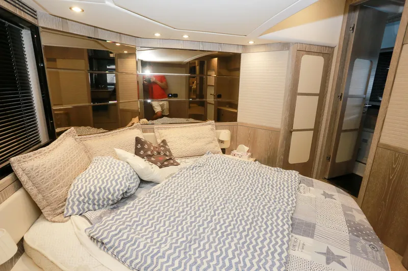  Yacht Photos Pics Luxurious bedroom interior of 2019 Azimut Magellano 53 yacht with cozy bedding.