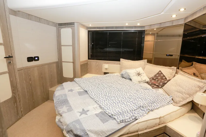  Yacht Photos Pics Luxurious bedroom interior of 2019 Azimut Magellano 53 yacht with cozy bedding.