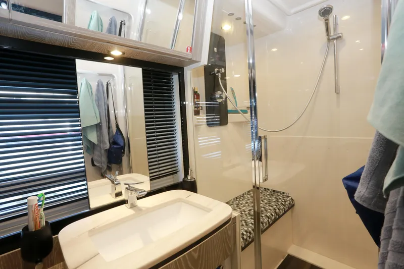  Yacht Photos Pics Bathroom interior of 2019 Azimut Magellano 53 yacht, featuring modern shower and sink.