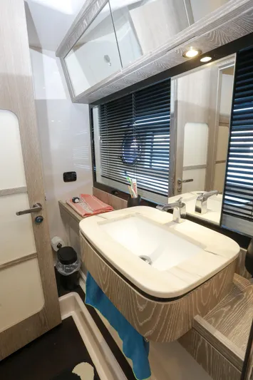  Yacht Photos Pics Bathroom interior of 2019 Azimut Magellano 53 yacht, featuring modern sink and mirror.