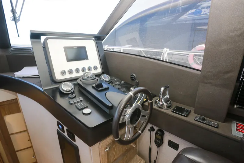  Yacht Photos Pics Cockpit of 2019 Azimut Magellano 53 yacht with modern navigation controls and steering wheel.
