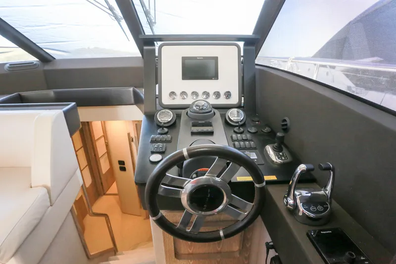  Yacht Photos Pics Helm of 2019 Azimut Magellano 53 yacht with modern controls and steering wheel.