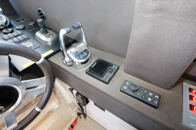  Yacht Photos Pics Control panel of 2019 Azimut Magellano 53 yacht with steering wheel and throttle levers.