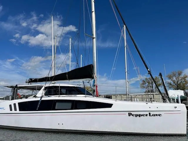 Pepper Love Yacht Photos Pics 2020 Seawind 1190 Sport catamaran "Pepper Love" docked under blue sky.