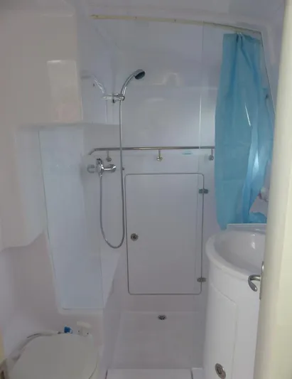 Pepper Love Yacht Photos Pics Modern bathroom in 2020 Seawind 1190 Sport catamaran with shower, sink, and toilet.