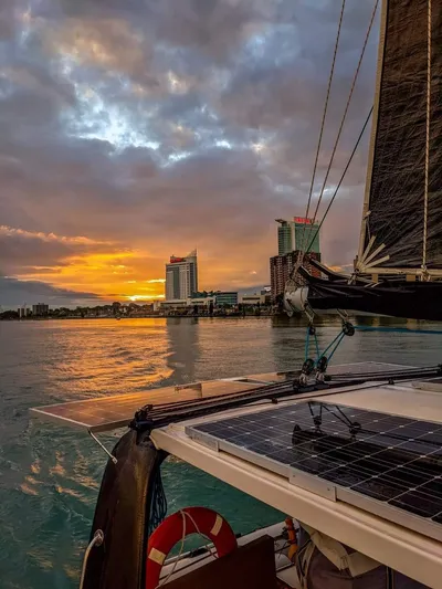 Pepper Love Yacht Photos Pics Seawind 1190 Sport 2020 sailing at sunset near city skyline.