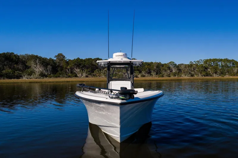  Yacht Photos Pics 2023 Yellowfin 32 Offshore boat on calm water under clear blue sky.