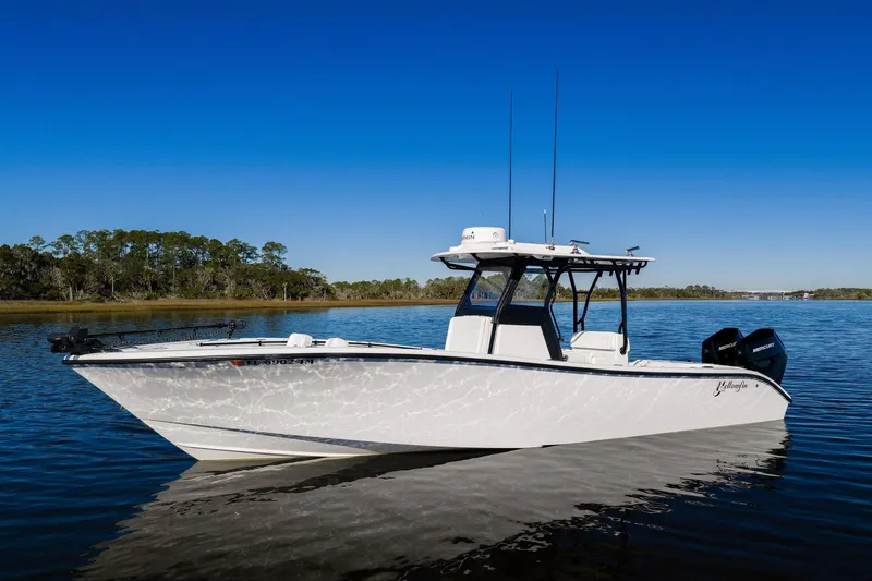  Yacht Photos Pics 2023 Yellowfin 32 Offshore boat on calm water under clear blue sky.