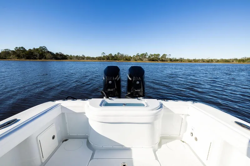  Yacht Photos Pics 2023 Yellowfin 32 Offshore boat with dual engines on a calm lake.