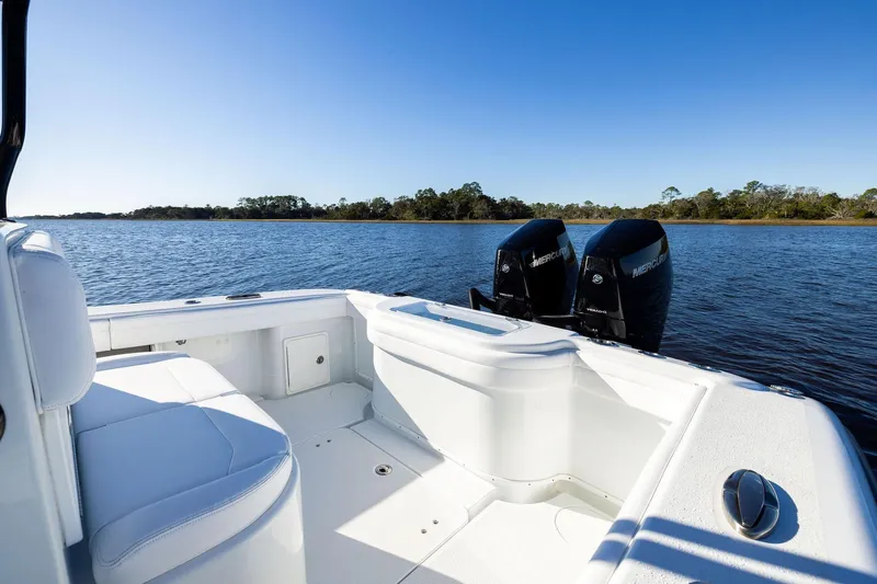  Yacht Photos Pics 2023 Yellowfin 32 Offshore boat with twin Mercury engines on a calm lake.