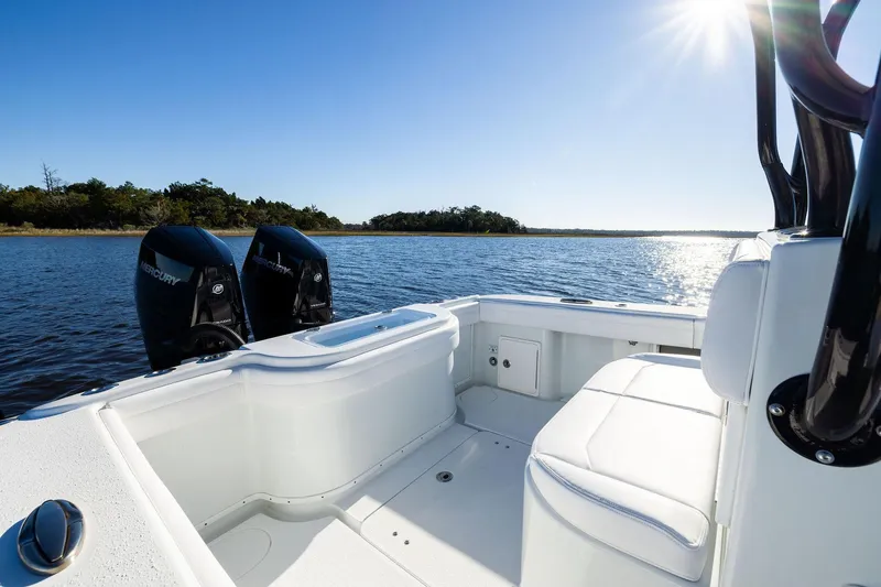  Yacht Photos Pics 2023 Yellowfin 32 Offshore boat interior with twin Mercury engines on a sunny day.