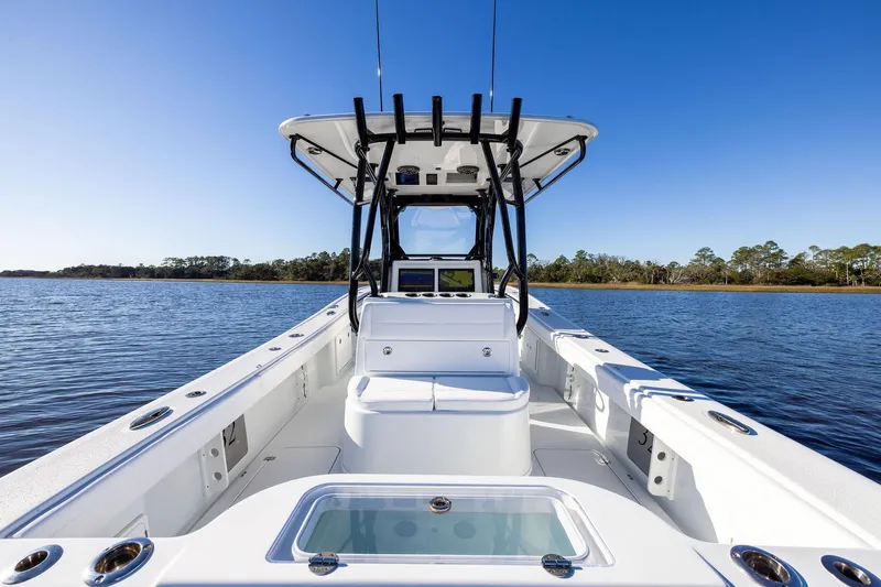  Yacht Photos Pics 2023 Yellowfin 32 Offshore boat on calm water, clear blue sky background.