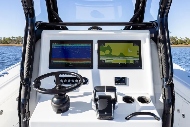  Yacht Photos Pics 2023 Yellowfin 32 Offshore boat dashboard with dual navigation screens and steering wheel.