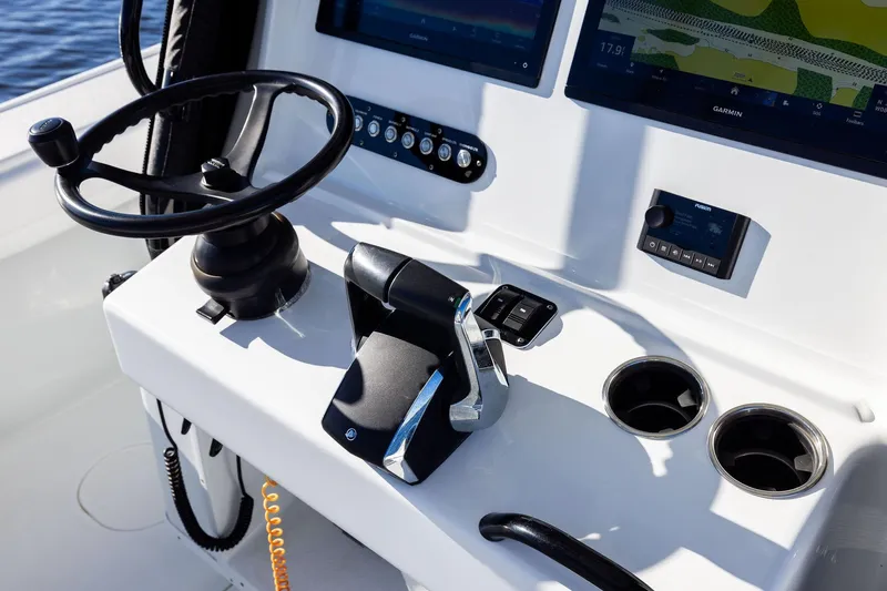  Yacht Photos Pics 2023 Yellowfin 32 Offshore boat helm with steering wheel and navigation screens.