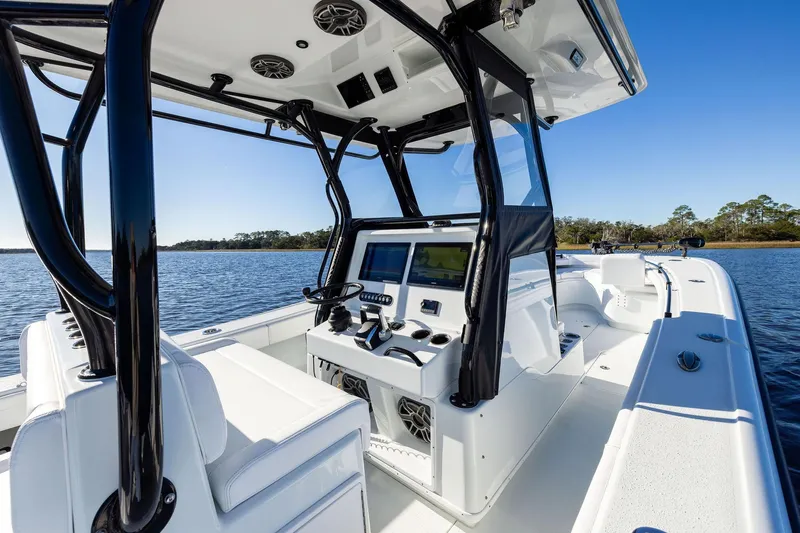  Yacht Photos Pics 2023 Yellowfin 32 Offshore boat interior with modern console on calm water.