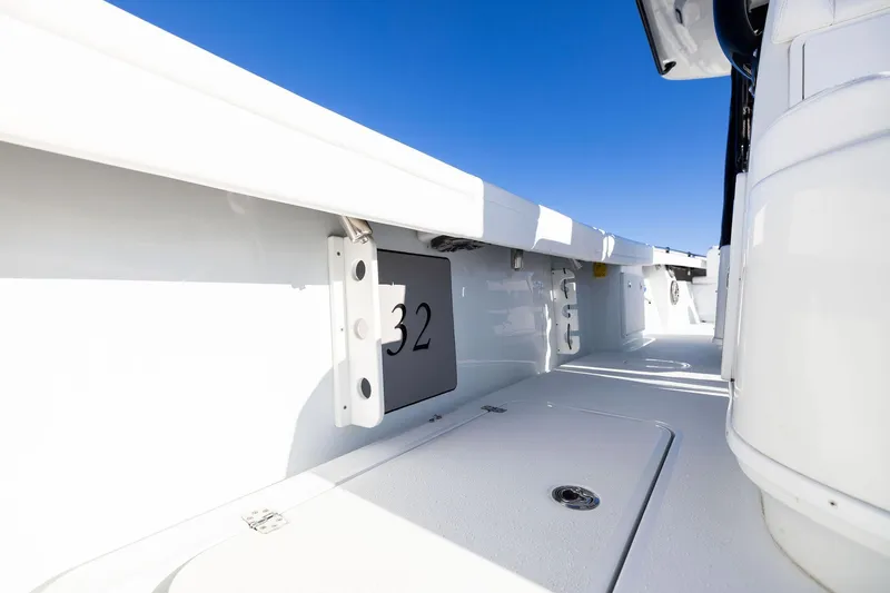  Yacht Photos Pics 2023 Yellowfin 32 Offshore boat interior with sleek white deck and clear blue sky.