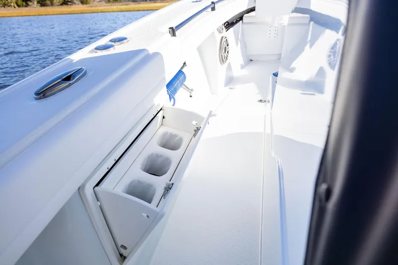  Yacht Photos Pics 2023 Yellowfin 32 Offshore boat interior with cup holders and sleek design.