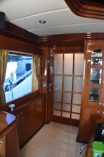 Magic Moments Yacht Photos Pics Luxurious 2006 Johnson Country Kitchen interior with wooden cabinetry and frosted glass door.