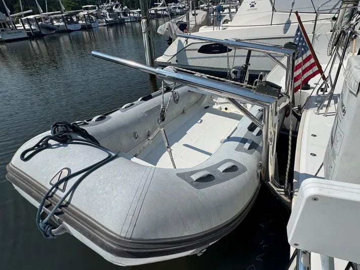 Serenity Yacht Photos Pics Inflatable dinghy docked beside a 2016 Lagoon 400 S2 catamaran with an American flag.