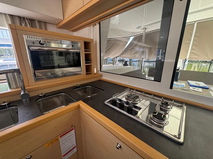 Serenity Yacht Photos Pics Modern kitchen in 2016 Lagoon 400 S2 yacht with stove, oven, and dual sinks.