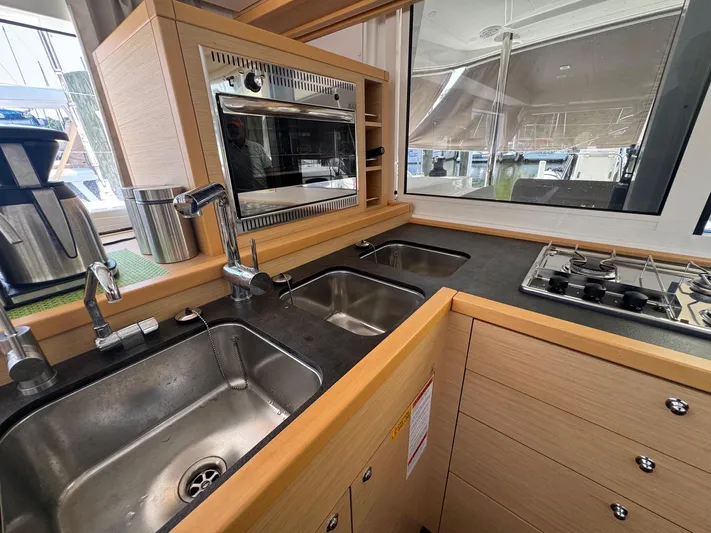 Serenity Yacht Photos Pics Modern kitchen in 2016 Lagoon 400 S2 yacht with dual sinks and stove.