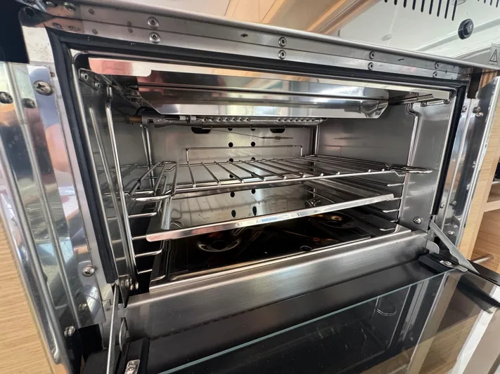 Serenity Yacht Photos Pics Open stainless steel oven inside a 2016 Lagoon 400 S2 yacht kitchen.