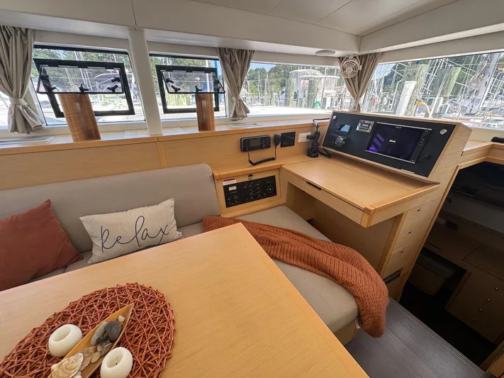 Serenity Yacht Photos Pics Interior of 2016 Lagoon 400 S2 catamaran with cozy seating and navigation station.
