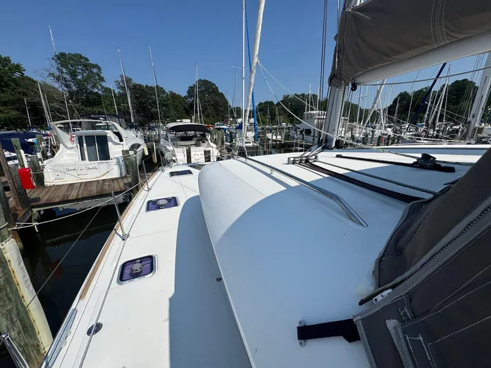 Serenity Yacht Photos Pics 2016 Lagoon 400 S2 catamaran docked at a marina, surrounded by other boats.