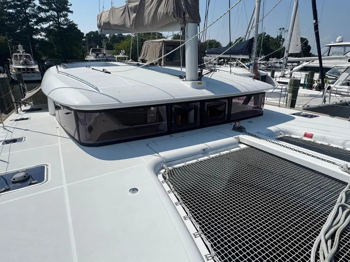 Serenity Yacht Photos Pics 2016 Lagoon 400 S2 catamaran docked, featuring spacious deck and netting.