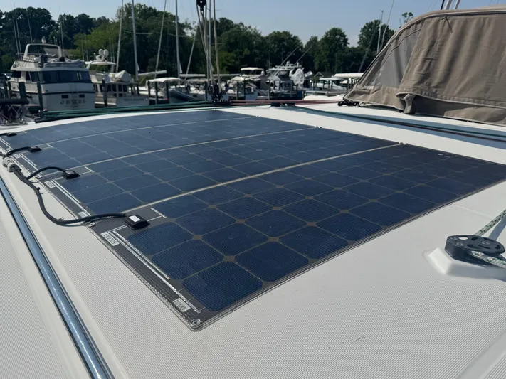Serenity Yacht Photos Pics Solar panels on a 2016 Lagoon 400 S2 catamaran, docked at a marina.