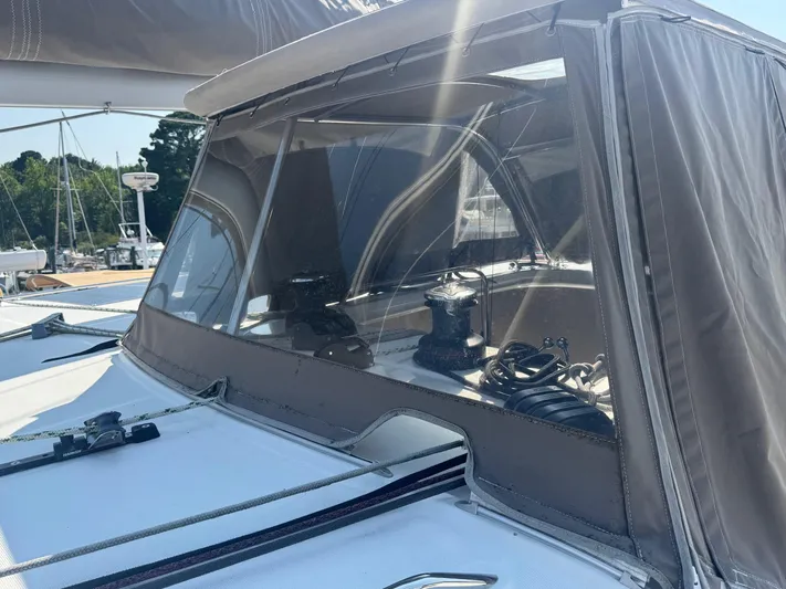 Serenity Yacht Photos Pics 2016 Lagoon 400 S2 yacht with covered cockpit and winch, docked in a marina.