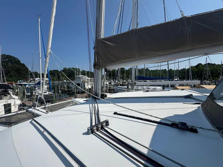 Serenity Yacht Photos Pics 2016 Lagoon 400 S2 catamaran docked at a marina under clear blue skies.