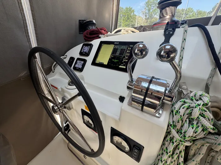 Serenity Yacht Photos Pics Helm of 2016 Lagoon 400 S2 catamaran with navigation controls and steering wheel.