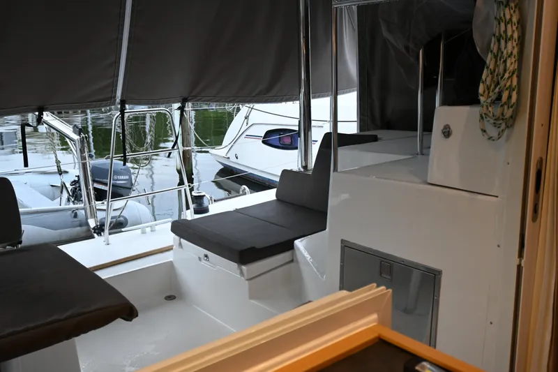 Serenity Yacht Photos Pics 2016 Lagoon 400 S2 yacht interior with seating and Yamaha motor in marina.