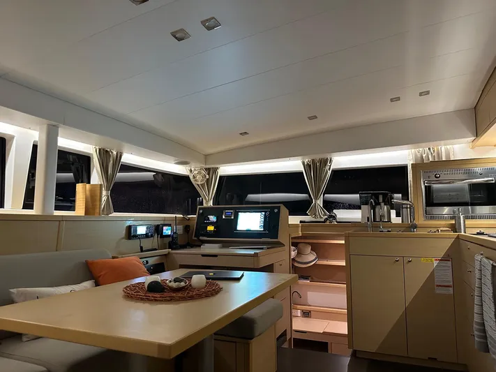 Serenity Yacht Photos Pics Interior of 2016 Lagoon 400 S2 catamaran with modern kitchen and navigation area.