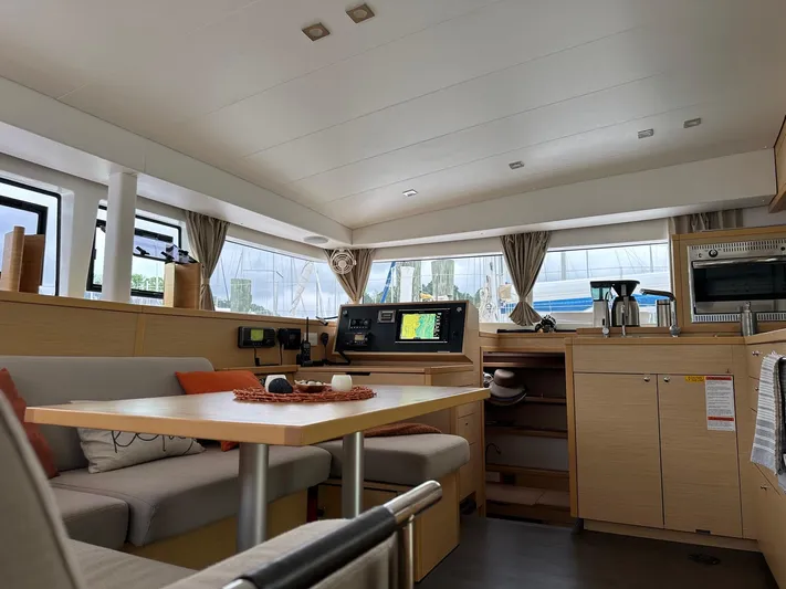 Serenity Yacht Photos Pics Interior of 2016 Lagoon 400 S2 catamaran, featuring modern kitchen and cozy seating area.