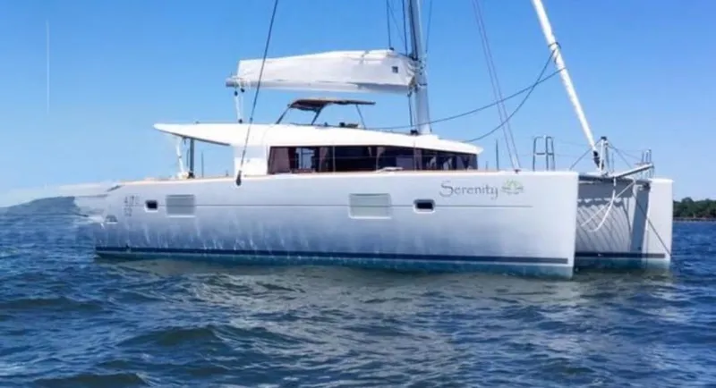 Serenity Yacht Photos Pics 2016 Lagoon 400 S2 catamaran sailing on calm waters under a clear blue sky.