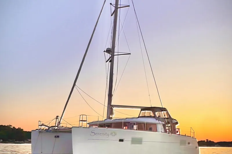 Serenity Yacht Photos Pics 2016 Lagoon 400 S2 catamaran at sunset on calm waters.