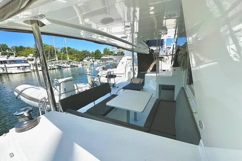 Serenity Yacht Photos Pics 2016 Lagoon 400 S2 yacht interior with seating area, docked at marina.