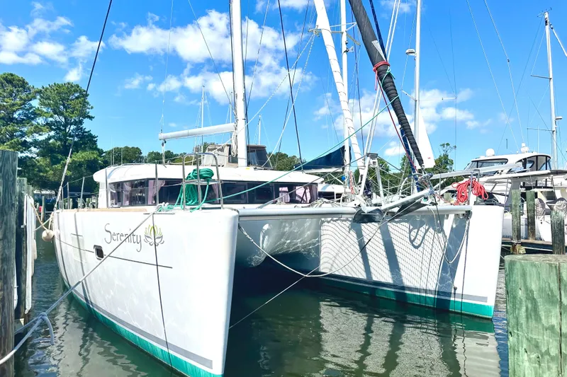 Serenity Yacht Photos Pics 2016 Lagoon 400 S2 catamaran docked in a marina under a clear blue sky.