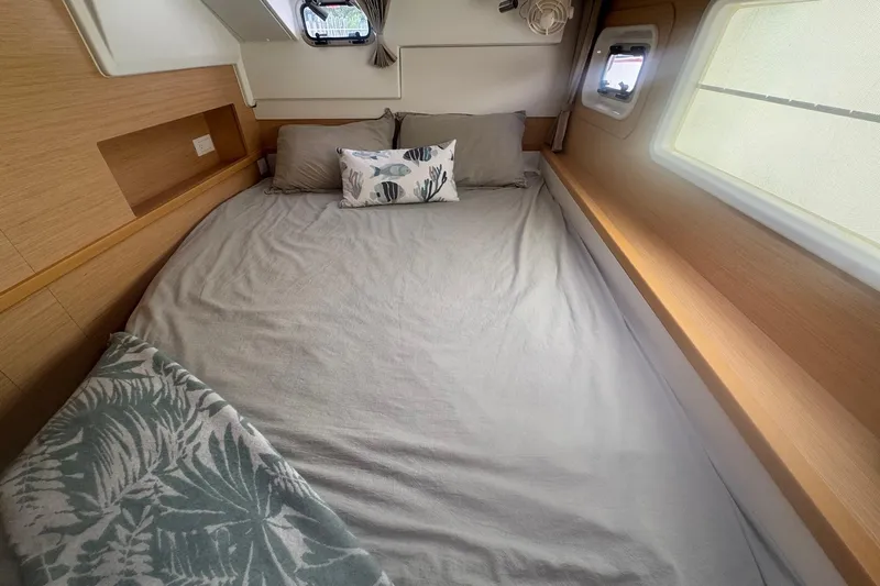 Serenity Yacht Photos Pics Cozy cabin interior of 2016 Lagoon 400 S2 catamaran with comfortable bedding and natural light.