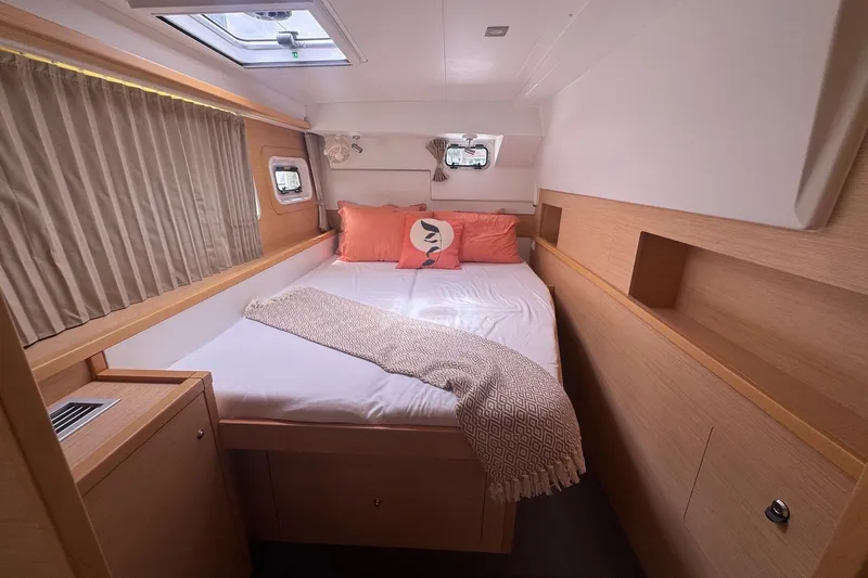 Serenity Yacht Photos Pics Cozy bedroom in 2016 Lagoon 400 S2 yacht with natural wood finish.