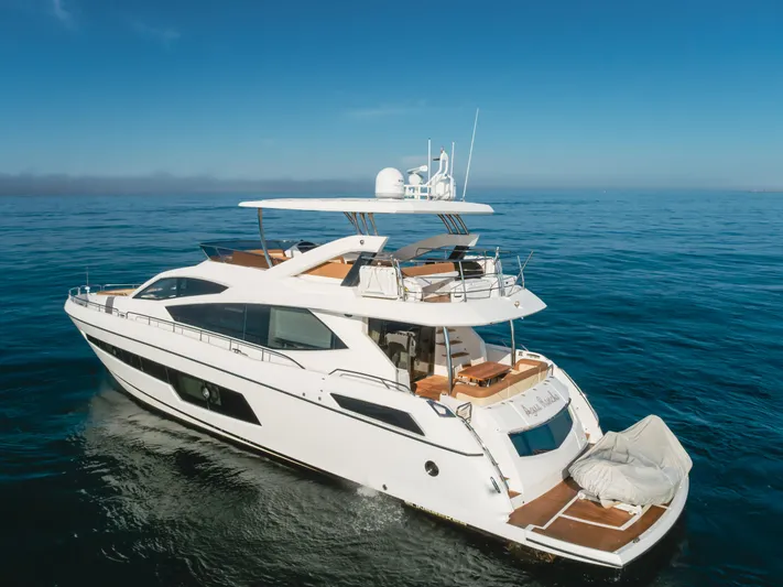 Agua Rancho Yacht Photos Pics 2017 Sunseeker 75 Yacht cruising on open sea under clear blue sky.