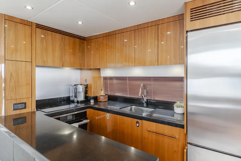 Agua Rancho Yacht Photos Pics Luxurious kitchen interior of 2017 Sunseeker 75 Yacht with modern appliances and wood cabinetry.