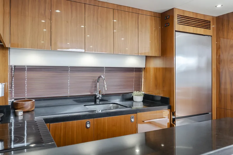 Agua Rancho Yacht Photos Pics Modern kitchen interior on 2017 Sunseeker 75 Yacht with sleek wood cabinetry and stainless steel appliances.