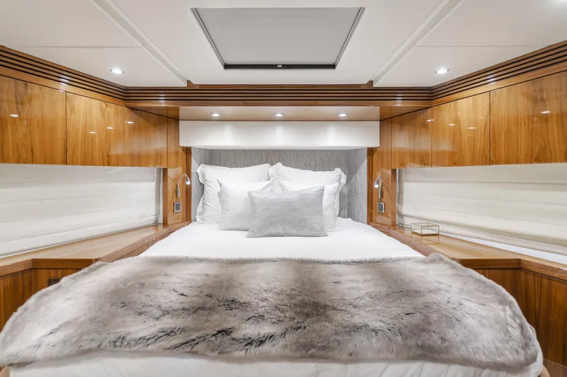 Agua Rancho Yacht Photos Pics Luxurious bedroom interior of 2017 Sunseeker 75 Yacht with elegant wood paneling and plush bedding.