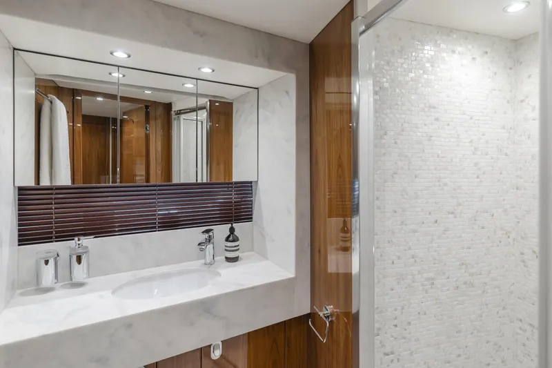 Agua Rancho Yacht Photos Pics Luxurious bathroom in a 2017 Sunseeker 75 Yacht, featuring elegant marble and wood finishes.
